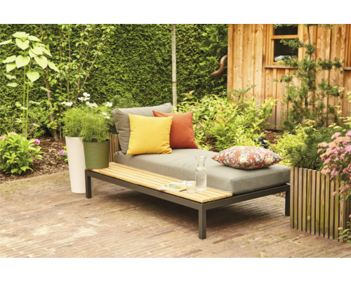 Garten Szene mit Liege, Kissen, Pflanzen und Holzhütte