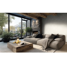 Helles Wohnzimmer mit grauem Stoffsofa, rustikalem Holztisch, Steinkamin und grossen Fenstern. Wand mit dezent gemusterter Tapete und Deckenbalken.
