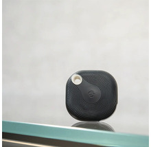 Schwarzer Bluetooth-Tracker mit Wellenmuster und runder Öffnung zur Befestigung.