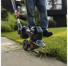 Rasentrimmer im Einsatz zum Kantenschneiden von Rasenflächen