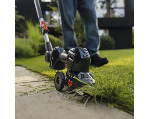Rasentrimmer im Einsatz zum Kantenschneiden von Rasenflächen
