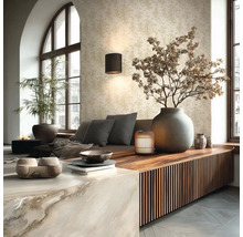 Hell gestaltetes Wohnzimmer mit Mustertapete, Wandlampe, Holz-Sideboard mit Lamellen und großer Steinvase mit Trockenzweigen.