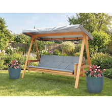 Holzschaukel mit grauen Auflagen und Dach im Garten