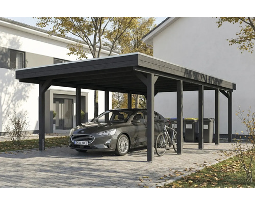 Carport mit Auto, Fahrrad und Mülltonnen vor einem Wohnhaus