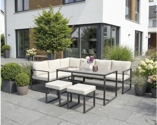 Gartensitzgruppe mit Eckbank, Tisch und Hockern auf einer Terrasse vor einem modernen Haus