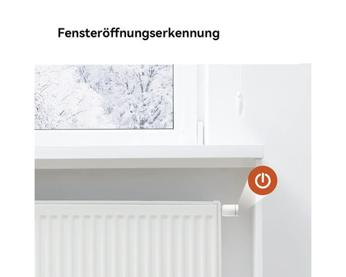 Heizkörperthermostat mit Fensteröffnungserkennung an einem Heizkörper unter einem Fenster mit winterlicher Aussicht.