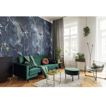 Modernes Wohnzimmer mit dunkelblauer Marmor-Tapete, grünem Samtsofa und Fischgrätenparkett. Dekoriert mit Zimmerpflanzen und Goldakzenten.