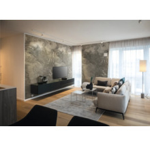 Modernes Wohnzimmer mit Marmoreffekt-Wand, schwarzem Hängeboard, hellem Ecksofa, Holzboden und hellen Fenstern mit transparenten Vorhängen.