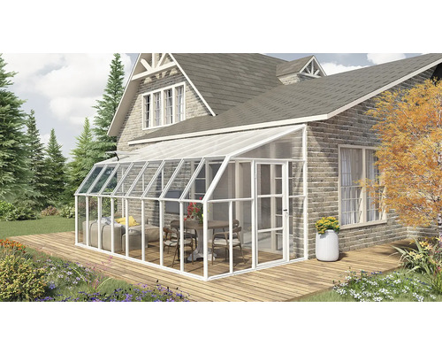 Moderner weißer Wintergarten aus Aluminium und Glas an einer Backsteinwand auf einer Holzterrasse mit Gartenmöbeln im hellen Außenbereich.