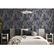 Schlafzimmer mit botanisch gemusterter Tapete mit verschiedenen Blattdesigns. Davor steht ein Bett mit hellem Kopfteil und dekorativen Kissen.