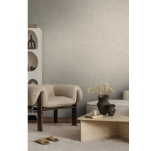 Strukturierte Wandgestaltung in Beige in einem modern eingerichteten Wohnzimmer mit Sessel und Couchtisch.