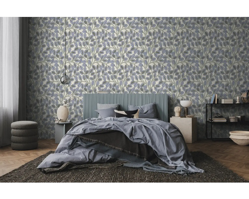 Helles, modernes Schlafzimmer mit Vliestapete mit lila und grünem Blättermuster, einem gepolsterten Bett und Holzboden.