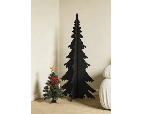 Minimalistischer schwarzer Weihnachtsbaum aus Holz neben einem kleinen geschmückten künstlichen Tannenbaum in einer hellen Zimmerecke.