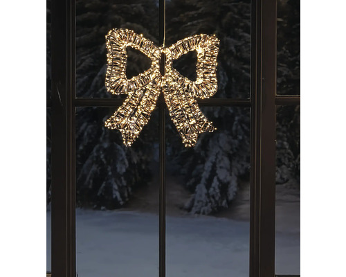 Beleuchtete LED-Schleife mit warmweißen Lichtern vor einem Fenster mit winterlicher Aussicht.
