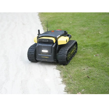 Yarbo autonomer Gartenroboter mit Kettenantrieb auf einer Rasenfläche neben einem Weg.