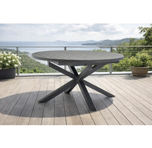 Moderner runder Gartentisch aus Metall mit sternförmigem Gestell auf einer hellen Terrasse mit Meerblick.