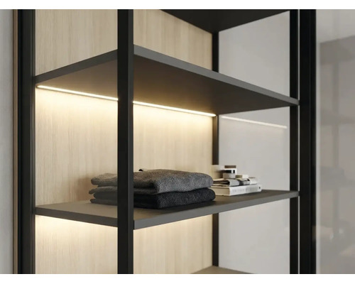 Modernes Regalsystem mit schwarzem Rahmen, integrierter LED-Beleuchtung unter den Fachböden und einer Rückwand in Holzoptik.