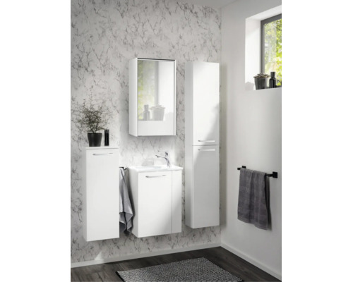 Modernes weißes Badezimmer-Set bestehend aus Waschbeckenunterschrank, Spiegelschrank, Hochschrank und Seitenschrank vor Wand mit Marmormuster.
