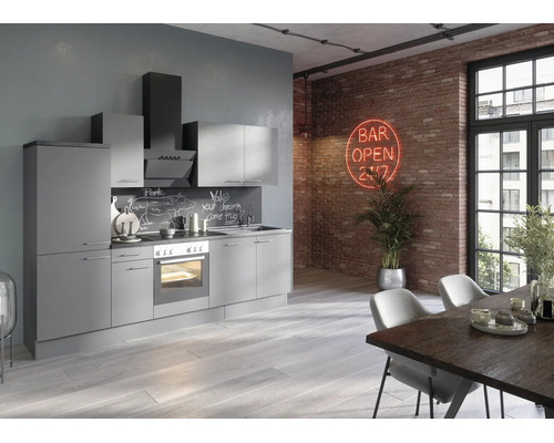 Moderne graue Küchenzeile im Loft-Stil mit Elektrogeräten vor einer Ziegelwand mit Neonschild und einem Esstisch im Vordergrund.