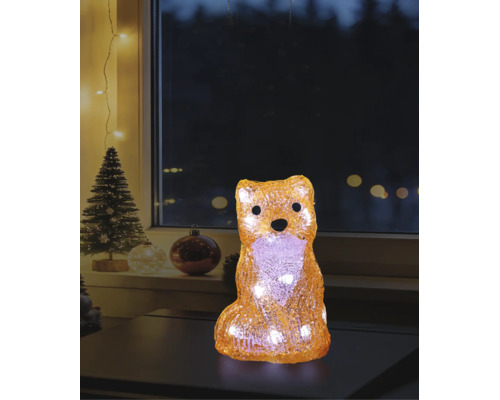 LED-Deko-Figur Fuchs aus Acryl mit warmweißem Licht in weihnachtlicher Atmosphäre auf einem Tisch vor einem Fenster.