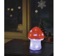 Beleuchteter LED-Deko-Fliegenpilz aus Acryl auf einem Tisch, weihnachtliche Fensterdekoration im Hintergrund.