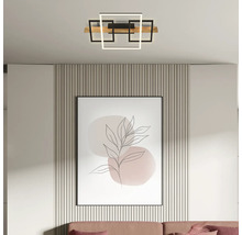 Moderne LED-Deckenleuchte mit geometrischen, quadratischen Rahmen und einem Holzelement, montiert in einem hellen, modern eingerichteten Raum.