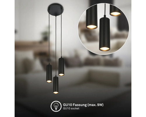 Dreiflammige schwarze Pendelleuchte mit zylindrischen, geriffelten Schirmen und GU10-Fassung für maximal 9 Watt in einem hellen Wohnzimmer.