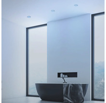 Modernes Badezimmer mit freistehender Badewanne, bodentiefen Fenstern und integrierter Wandnische, minimalistisches Design.
