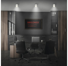 Modernes Arbeitszimmer mit drei zylindrischen LED Deckenstrahlern von Briloner, die den Schreibtisch beleuchten.