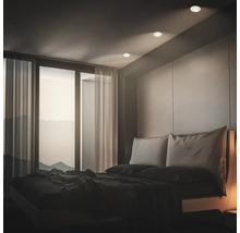 Modernes Schlafzimmer mit Einbauleuchten an der Decke, bodentiefen Fenstern und Panoramablick.