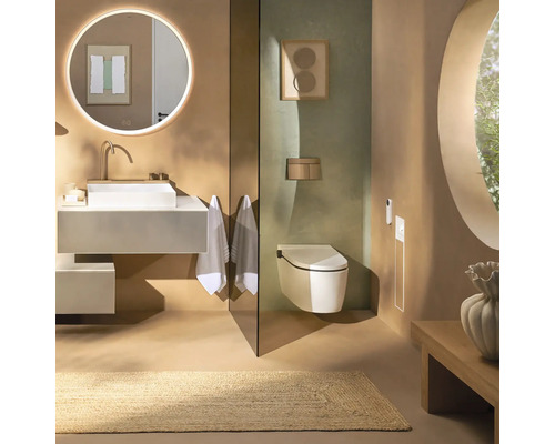 Modernes Badezimmer mit weißem Aufsatzwaschbecken, rundem Leuchtspiegel, Wand-WC und Naturteppich in erdigen Tönen.