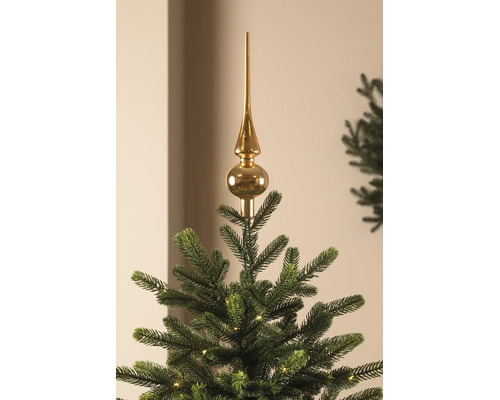 Glänzende Christbaumspitze auf einem Weihnachtsbaum mit Lichtern.