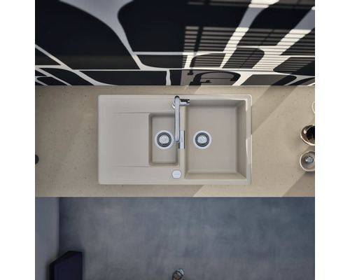 Einbauspüle mit anderthalb Becken und Abtropffläche inklusive verchromter Küchenarmatur in einer Arbeitsplatte, Ansicht von oben.