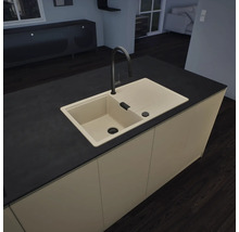 Moderne Kücheninsel mit beige Einbauspüle aus Verbundwerkstoff, Abtropffläche und einer hohen, schwarzen Armatur. Dunkle Arbeitsplatte.