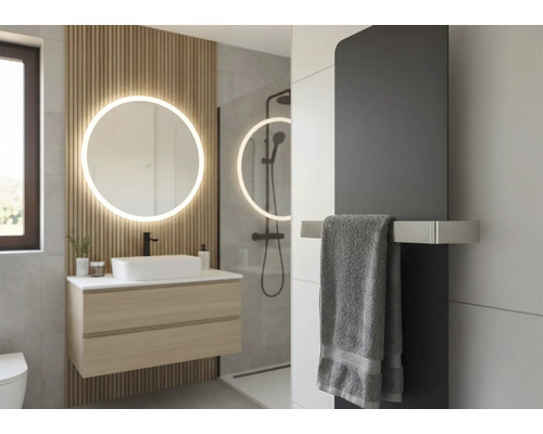 Modernes Badezimmer mit rundem beleuchtetem Spiegel, Wandpaneelen aus Holz, hängendem Waschtisch, Aufsatzbecken und dunklem Heizkörper.