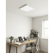 Modernes Homeoffice mit quadratischem LED-Deckenpanel, Holzschreibtisch, Bürostuhl, Laptop und Zimmerpflanze. Helle, minimalistische Einrichtung.