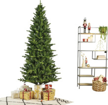 Künstlicher Weihnachtsbaum in einem modern dekorierten Raum mit Geschenken und einem Metallregal mit Weihnachtsdekoration.