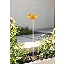 Heller, sonniger Außenbereich mit einem gelben Schmetterlings-Gartenstecker in einem Blumenkasten mit Margeriten und grünen Pflanzen.