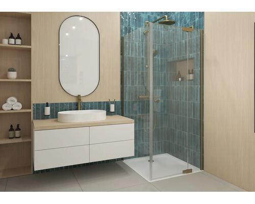 Modernes Badezimmer mit weißem Hängeschrank, ovalem Spiegel und Glasduschkabine mit goldfarbenen Armaturen und vertikalen blau-grünen Fliesen.