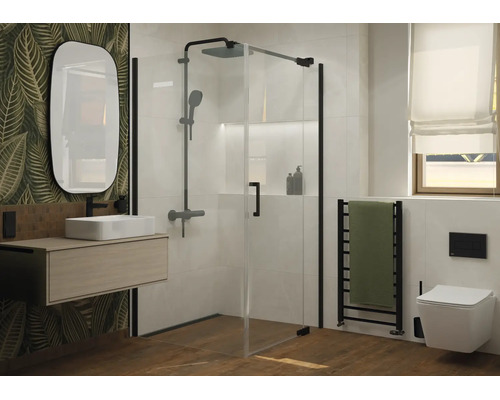 Modernes Badezimmer mit Glasduschkabine, wandhängendem Waschbecken, ovalem Spiegel und hängender Toilette vor einer Wand mit Blattmotiv.