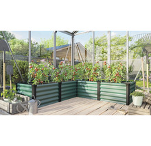 Winkel Hochbeet aus Metall in einem Gewächshaus mit angebauten Tomatenpflanzen auf einer Holzterrasse.