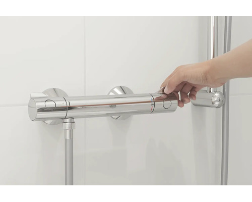 Hand bedient eine Grohe Thermostat Duscharmatur an einer gefliesten Wand