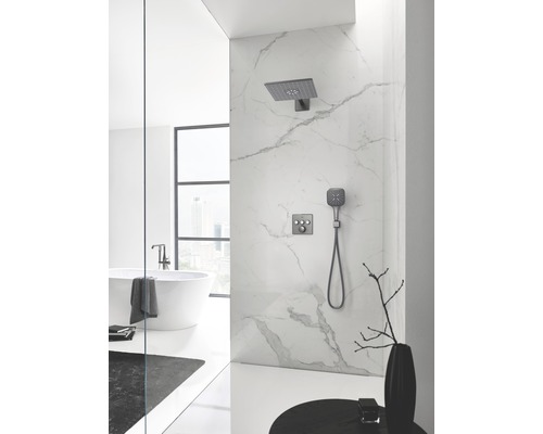 Badezimmer mit Marmorwand, Dusche mit Kopfbrause und Handbrause sowie freistehender Badewanne