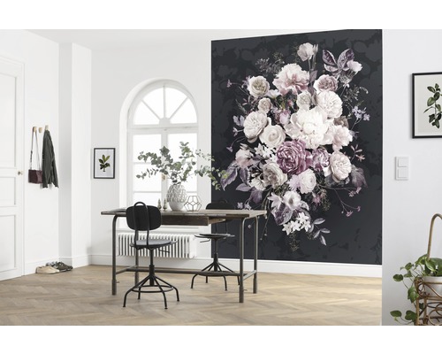 Dekoratives Zimmer mit einer schwarzen Fototapete mit Blumenmuster, einem Tisch, Stühlen und Pflanzen