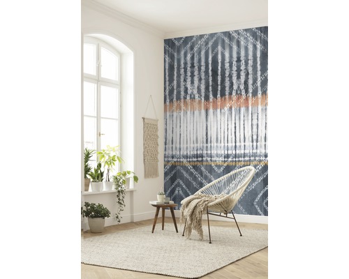 Wohnzimmer mit gemusterter Tapete, Sessel, Teppich und Zimmerpflanzen