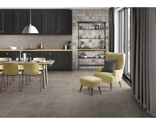 Beispiel eines Raumes mit Küchenzeile, Essbereich und Sessel auf Bodenfliesen.