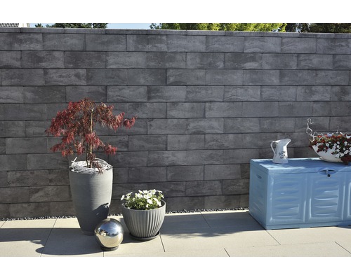 Gartenmauer aus Betonsteinen mit Pflanzen und Gartenbox