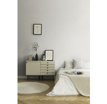 Schlafzimmer mit Kommode, Bett und runden Teppich