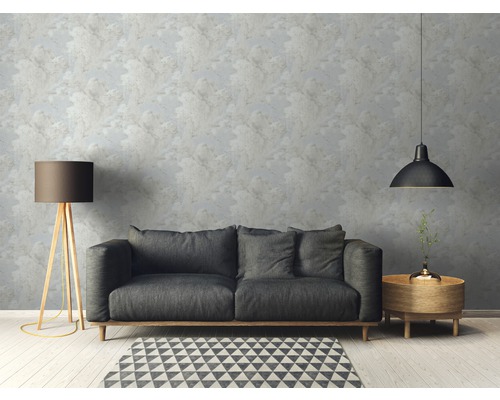 Wohnzimmer mit Sofa, Lampe und gemusterter Tapete