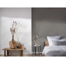 Schlafzimmer mit Bett, Nachttischlampe und Dekoration auf einem Holztisch